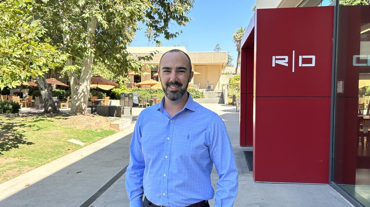 Graduate student Alex Johnson standing outside on Caltech campus