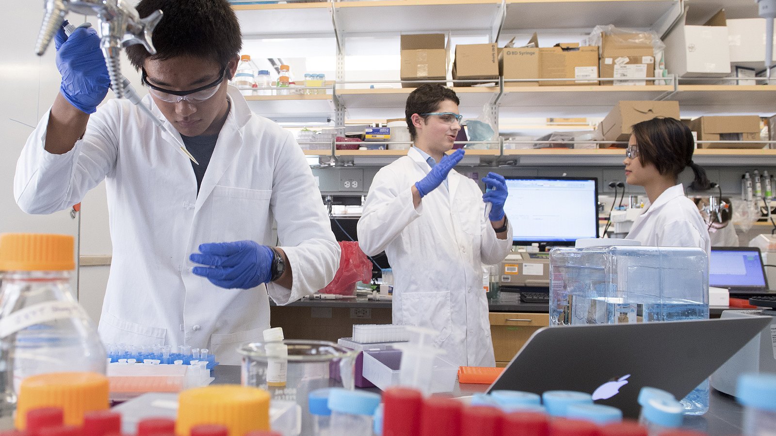 Three Caltech students working in a lab